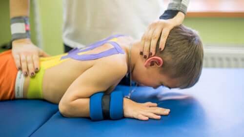 Physical Therapist Working With Cerebral Palsy Boy