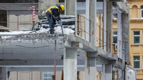 Construction Worker on Commercial Property Using Jackhammer
