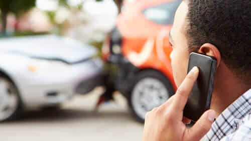 man-on-cellphone-with-lawyer-after-car-accident-geico-claims