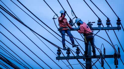 Linemen Power Workers Installing High Voltage Power Line