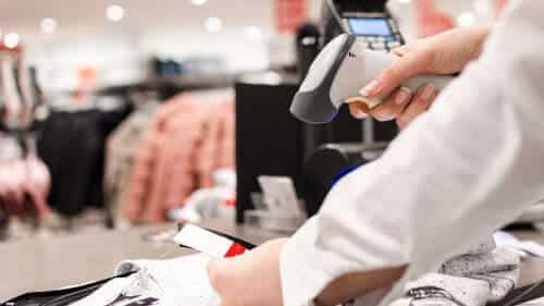 Female Retail Employee Scanning Clothing Price Tag